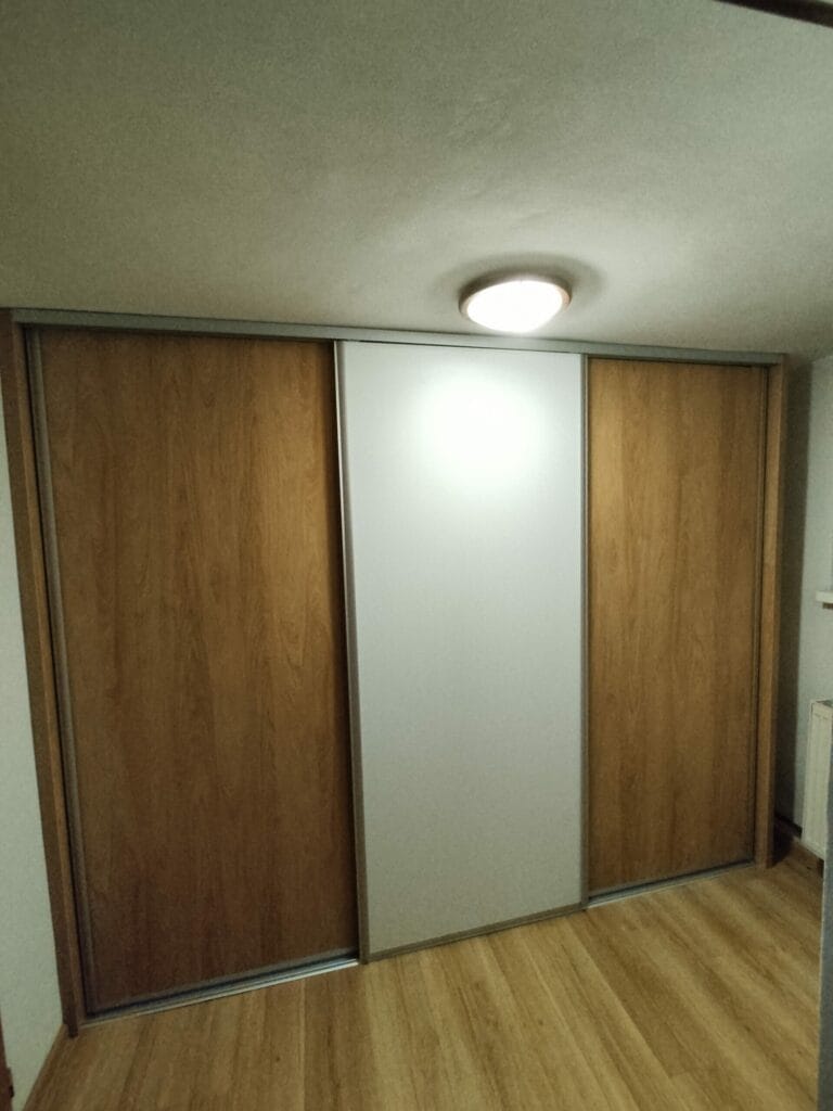 Vstavaná skriňa na mieru s posuvnými dverami a elegantným kombinovaným dekorom z dreva